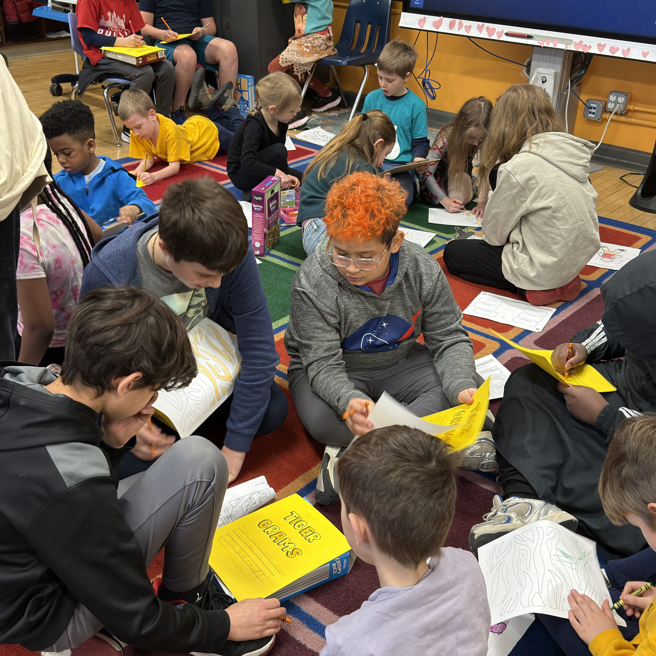 Students at Bache-Martin School work together on classroom activities while seated on a colorful rug.